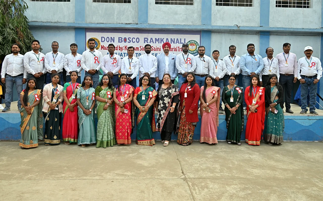 Staff members of Don Bosco Ramkanali standing together on the school campus